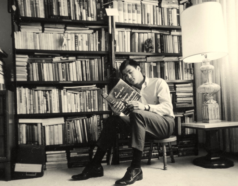 Bruce Lee reading a book